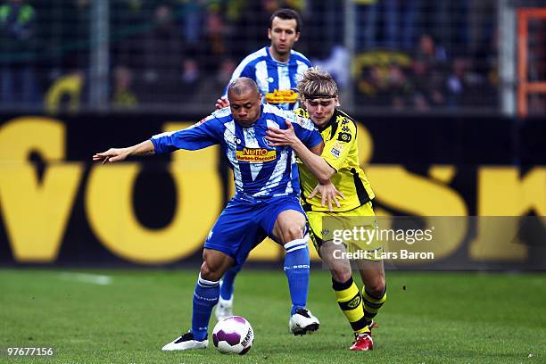 Joel Epalle of Bochum is challenged by Marcel Schmelzer of Dortmund during the Bundesliga match between VfL Bochum and Borussia Dortmund at...