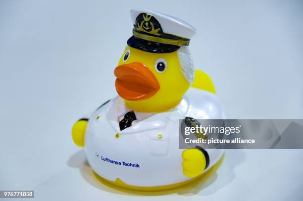 April 2018, Germany, Hamburg: A rubber duck featuring the uniform of an aircraft captain is on display at the fair stand of Lufthansa Technik at the...