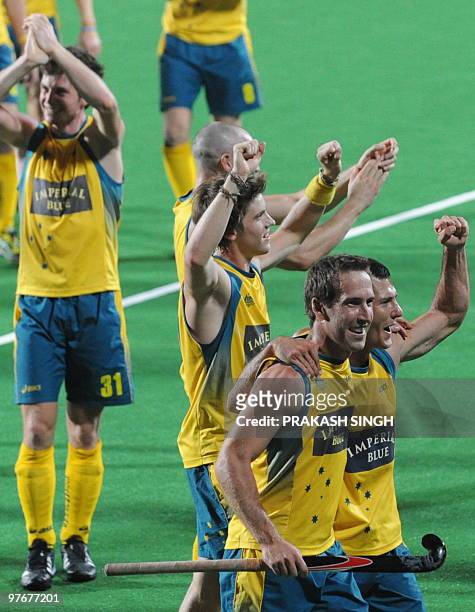 Australian hockey captain Jamie Dwyer celebrates with teammates after defeating Germany during their World Cup 2010 final match at the Major Dhyan...