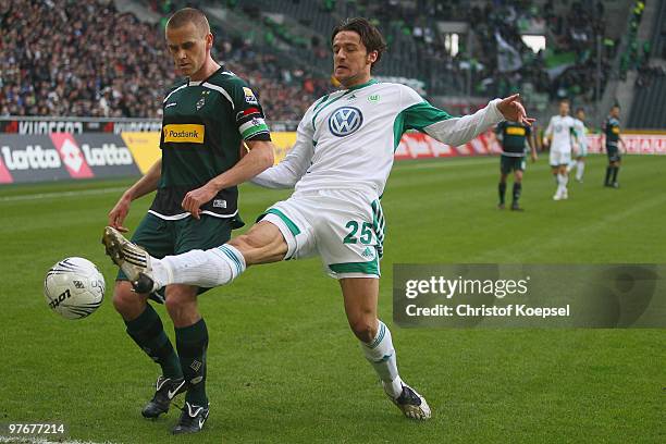 Christian Gentner of Wolfsburg challenges Filip Daems of Gladbach during the Bundesliga match between Borussia Moenchengladbach and VfL Wolfsburg at...