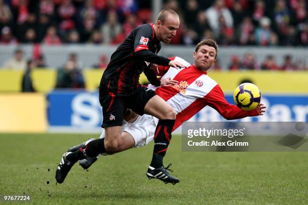 Miso Brecko of Koeln is challenged by Florian Heller of Mainz during the Bundesliga match between FSV Mainz 05 and 1. FC Koeln at the Bruchweg...