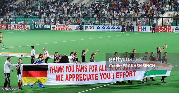 German hockey players acknowledge their supporters after the World Cup 2010 final match against Australia at the Major Dhyan Chand Stadium in New...
