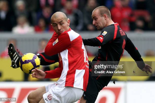 Miso Brecko of Koeln is challenged by Elkin Soto of Mainz during the Bundesliga match between FSV Mainz 05 and 1. FC Koeln at the Bruchweg Stadium on...
