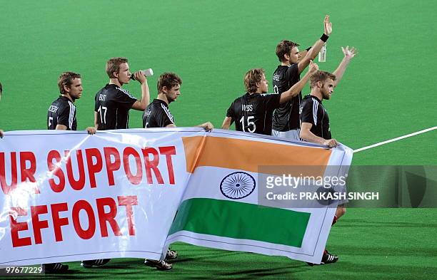German hockey players acknowledge their supporters after the World Cup 2010 final match against Australia at the Major Dhyan Chand Stadium in New...