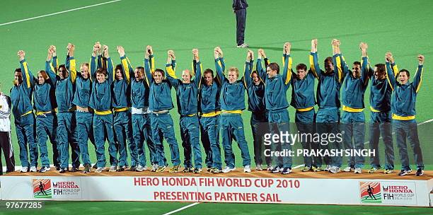 Australian hockey players gesture from the winner's podium during the award ceremony after defeating Germany in the World Cup 2010 final match at the...