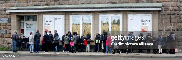 People queue to apply as new clients at the Essener Tafel food bank after foreigners were prohibited for the past three months from filing...