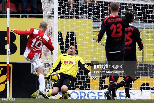 Goalkeeper Faryd Mondragon of Koeln makes a save against Elkin Soto of Mainz during the Bundesliga match between FSV Mainz 05 and 1. FC Koeln at the...