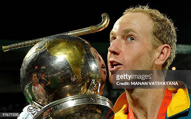 Australian hockey player Luke Doerner kisses the trophy after winning the World Cup 2010 Final match against Germany at the Major Dhyan Chand Stadium...