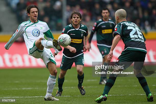 Marcel Meeuwis of Gladbach shoots at goal against Christian Gentner of Wolfsburg during the Bundesliga match between Borussia Moenchengladbach and...