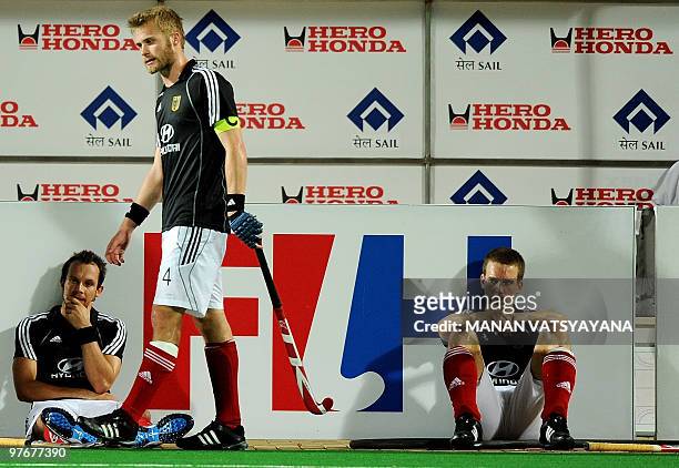 German hockey captain Maximilian Muller walks back dejected past the team dug-out after losing the World Cup 2010 Final match against Australia at...