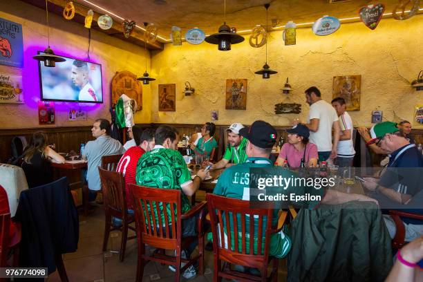 Fans watching the tv football match of the 2018 FIFA World Cup between Argentina and Iceland in the cafe at Moscow downtown on June 16, 2018 in...