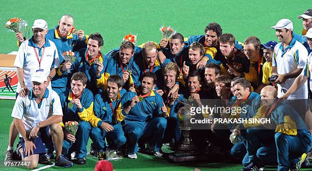Australian hockey players pose with the trophy after winning the World Cup 2010 Final match against Germany at the Major Dhyan Chand Stadium in New...