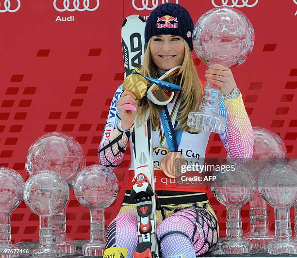 Overall world cup winner US Lindsey Vonn poses with globes in the finish area after the women's Alpine skiing World Cup Slalom finals in Garmisch...