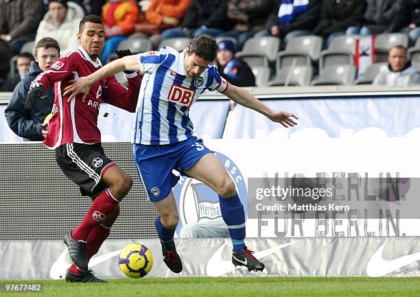 Arne Friedrich of Berlin battles for the ball with Eric Maxim Choupo-Moting of Nuernberg during the Bundesliga match between Hertha BSC Berlin and...