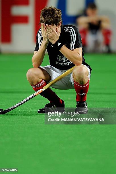 German hockey player Florian Fuchs sits dejected after losing the World Cup 2010 Final match against Australia at the Major Dhyan Chand Stadium in...