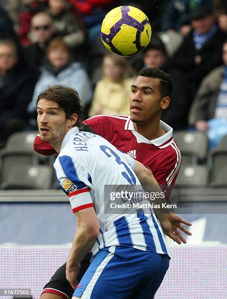 Arne Friedrich of Berlin battles for the ball with Eric Maxim Choupo-Moting of Nuernberg during the Bundesliga match between Hertha BSC Berlin and...