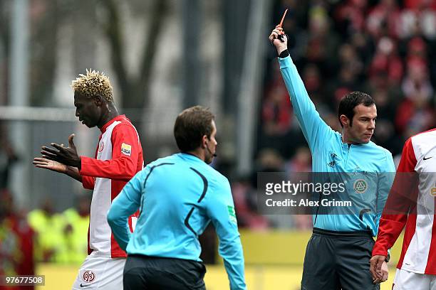 Aristide Bance of Mainz leaves the pitch after been sent off and booked red card by referee Marco Fritz during the Bundesliga match between FSV Mainz...