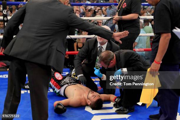 Officials check on Carlos Ocampo after he was knocked out by Errol Spence Jr. In the first round of a IBF Welterweight Championship bout at The Ford...