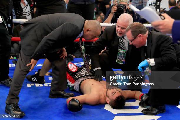 Officials check on Carlos Ocampo after he was knocked out by Errol Spence Jr. In the first round of a IBF Welterweight Championship bout at The Ford...