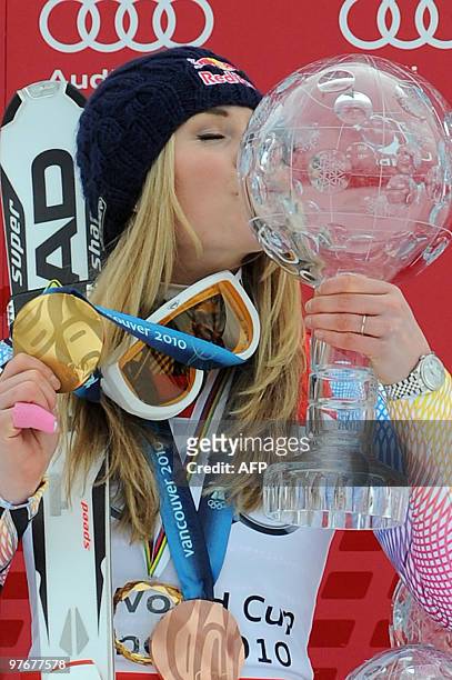 Overall world cup winner US Lindsey Vonn kisses the big globe in the finish area after the women's Alpine skiing World Cup Slalom finals in Garmisch...