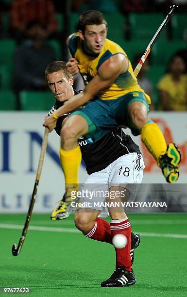 German hockey player Oliver Korn vies for the ball with Australian Hockey player Simon Orchard during their World Cup 2010 Final match against...