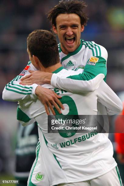 Edin Dzeko of Wolfsburg celebrates his team's second goal with tea, mate Christian Gentner during the Bundesliga match between Borussia...