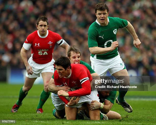 Thomas O'Leary of Ireland tackles James Hook of Wales during the RBS Six Nations match between Ireland and Wales at Croke Park Stadium on March 13,...