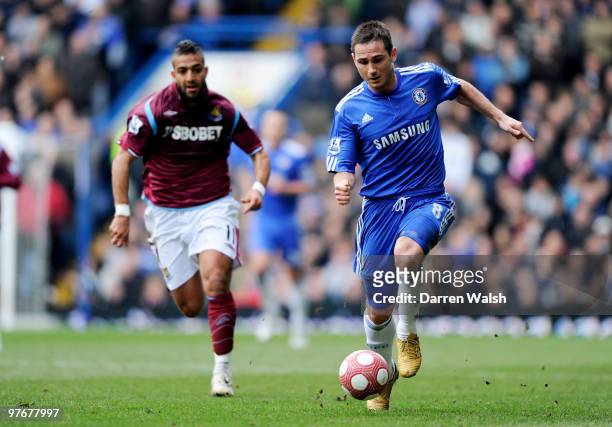 Frank Lampard of Chelsea is pursued by Mido of West Ham during the Barclays Premier League match between Chelsea and West Ham United at Stamford...