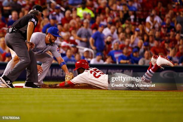 Dexter Fowler of the St. Louis Cardinals is thrown out at third base against Kris Bryant of the Chicago Cubs in the sixth inning at Busch Stadium on...