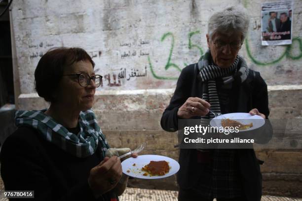 Dpatop - Tourists eat Kanafeh at Al-Aqsa sweets shop in the West Bank city of Nablus, 11 April 2018. Kanafeh, a traditional Arabic dessert made with...