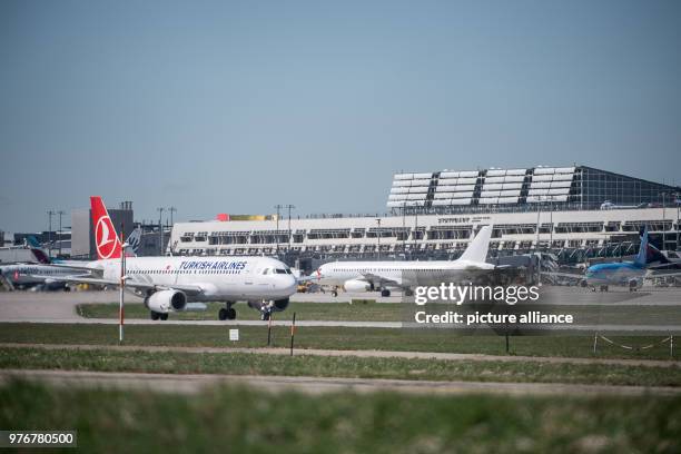 April 2018, Germany, Stuttgart: Airplanes stand on the manoeuvring area of the airport. According to Stuttgart's airport operator 'Flughafen...