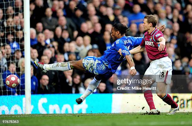 Didier Drogba of Chelsea is pulled down in the area by Jonathan Spector of West Ham, but play is waved on by the Referee Mark Clattenburg during the...