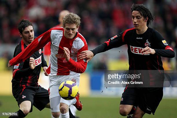 Andre Schuerrle of Mainz is challenged by Pedro Geromel and Fabrice Ehret of Koeln during the Bundesliga match between FSV Mainz 05 and 1. FC Koeln...