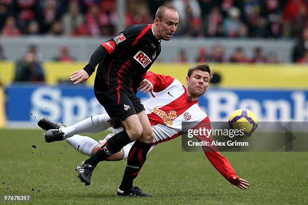 Miso Brecko of Koeln is challenged by Florian Heller of Mainz during the Bundesliga match between FSV Mainz 05 and 1. FC Koeln at the Bruchweg...