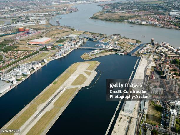 Aerial view City Airport from the east. Old Royal Docks, University of East London, Thames Barrier and Excel Exhibition Centre, London UK.