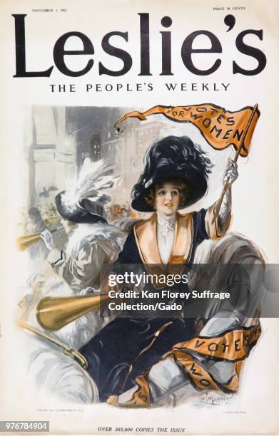 Color magazine cover, depicting a young suffragette, wearing blue and gold, riding in an open coach seat, in a parade, holding a bullhorn in one...