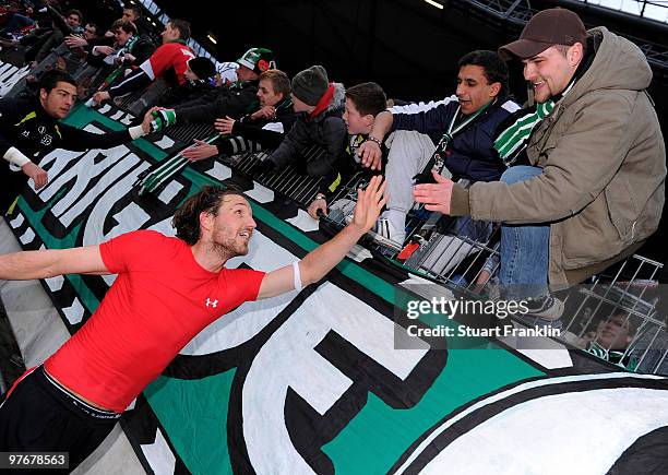 Christian Schulz of Hannover celebrates with fans at the end of the Bundesliga match between Hannover 96 and Eintracht Frankfurt at AWD-Arena on...