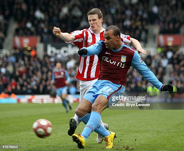 Gabriel Agbonlahor of Aston Villa is tackled by Robert Huth of Stoke City during the Barclays Premier League match between Stoke City and Aston Villa...