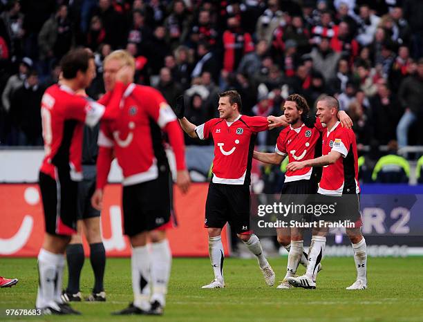 Arnold Bruggink, Christian Schulz and Leon Andreasen of Hannover celebrate at the end of the Bundesliga match between Hannover 96 and Eintracht...