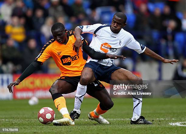Mohamed Diame of Wigan Athletic is tackled by Fabrice Muamba of Bolton Wanderers during the Barclays Premier League match between Bolton Wanderers...