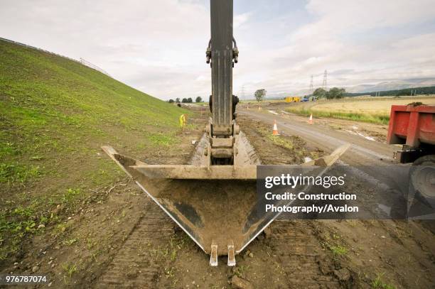Trapezoidal excavator bucket for digging drainage ditches.