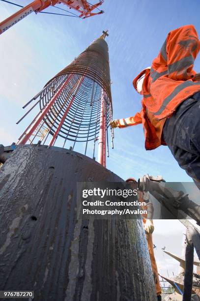 Construction crew at work fitting reinforcing into the piling.