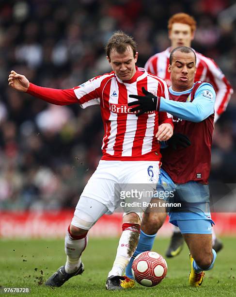 Gabriel Agbonlahor of Aston Villa tackles Glenn Whelan of Stoke City during the Barclays Premier League match between Stoke City and Aston Villa at...