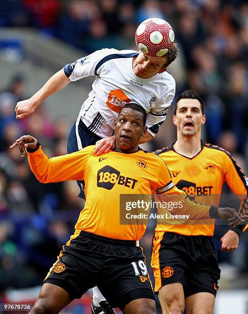 Kevin Davies of Bolton Wanderers wins the ball from Titus Bramble of Wigan Athletic during the Barclays Premier League match between Bolton Wanderers...