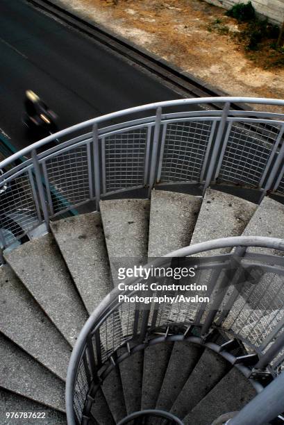 View of spiral staircase near the Musee d'Orsay with blurred motorcyclist below. Paris, France.