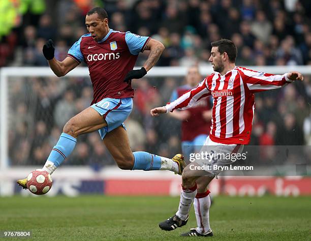 John Carew of Aston Villa avoids Rory Delap of Stoke City during the Barclays Premier League match between Stoke City and Aston Villa at Britannia...