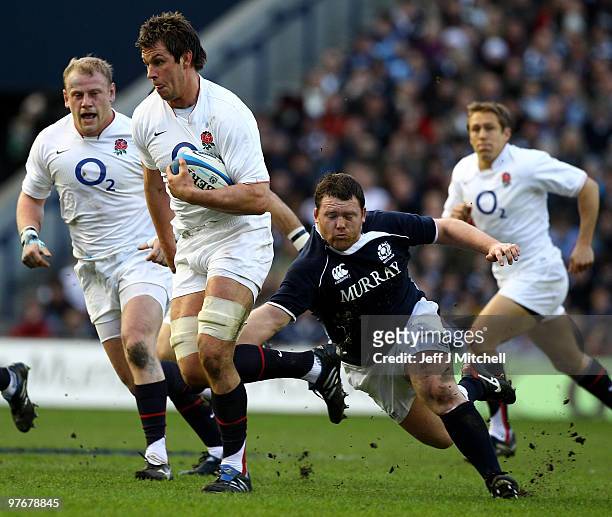 Alan Jacobsen of Scotland tackles Louis Deacon of England during the RBS Six Nations match between Scotland and England at Murrayfield Stadium on...