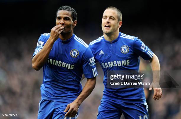 Florent Malouda of Chelsea is congratulated by teammate Joe Cole after scoring their team's third goal during the Barclays Premier League match...