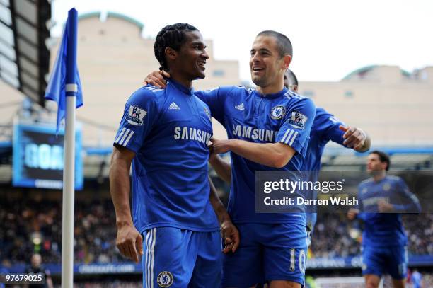 Florent Malouda of Chelsea is congratulated by teammate Joe Cole after scoring their team's third goal during the Barclays Premier League match...