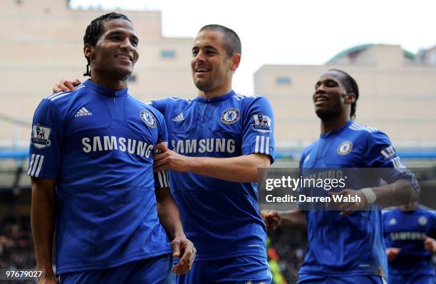 Florent Malouda of Chelsea is congratulated by teammates Joe Cole M and Didier Drogba after scoring their team's third goal during the Barclays...